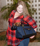 Dachshund puppy in dog carrier on shoulder